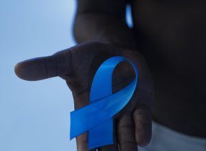 man-holding-blue-ribbon